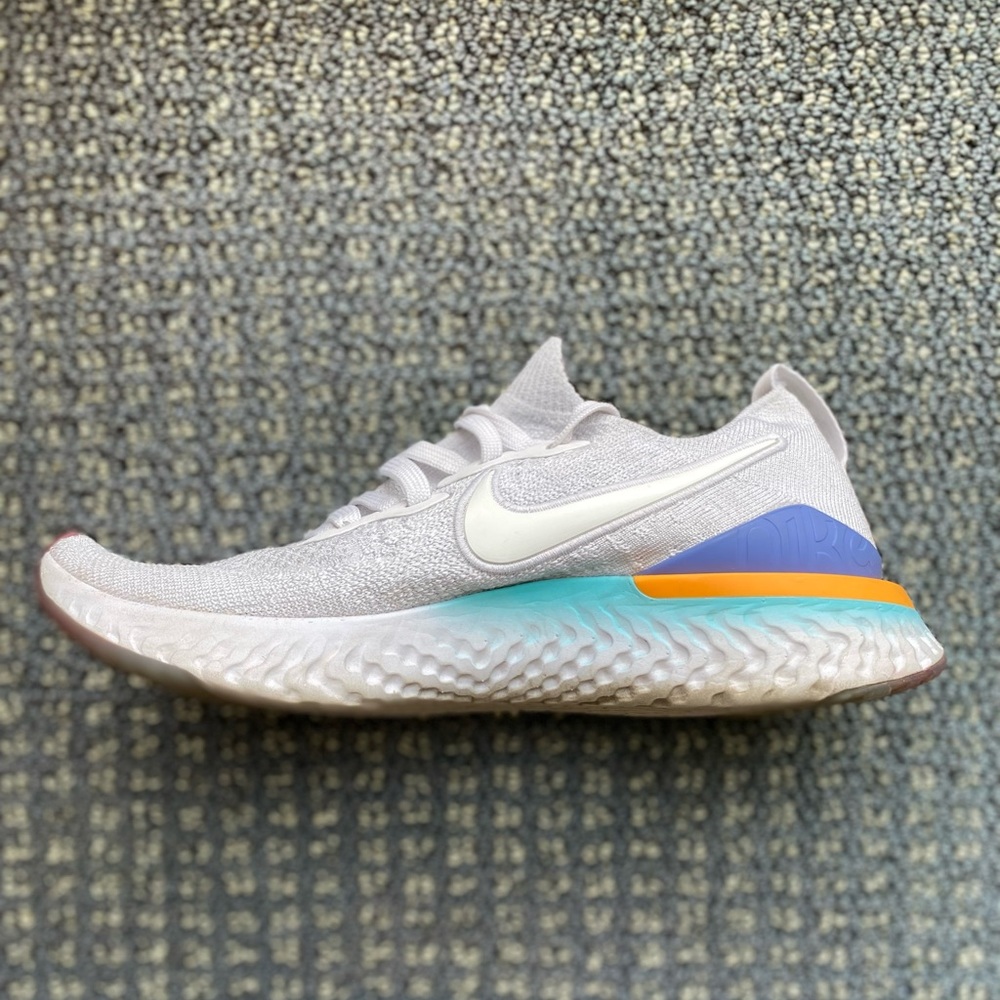 White and multicolor nike fly knit shoes